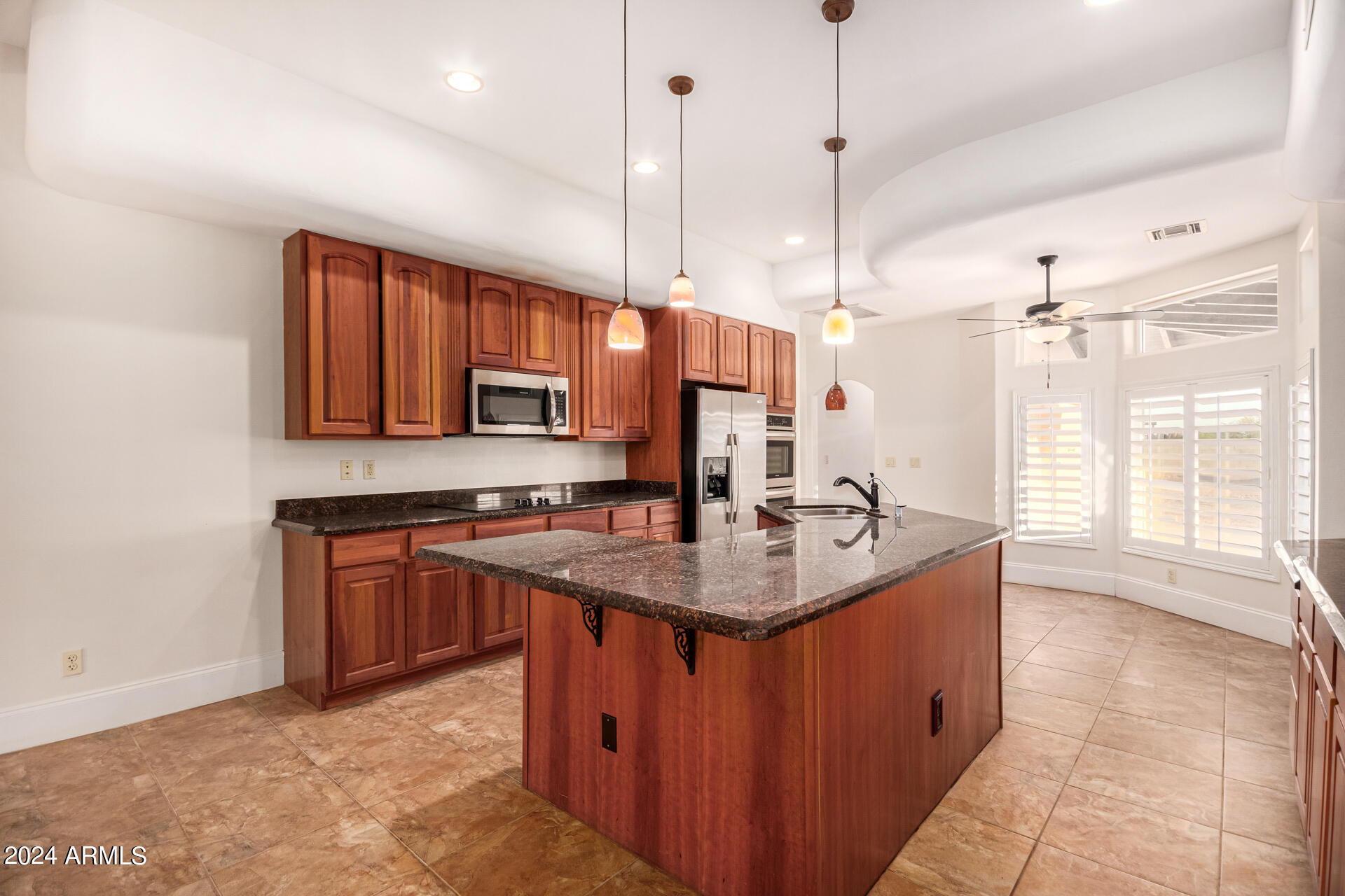 10589 West Harmon Road Eloy, AZ 85131 - Photo 32 of 82 a kitchen with stainless steel appliances granite countertop a sink a stove and a wooden floor