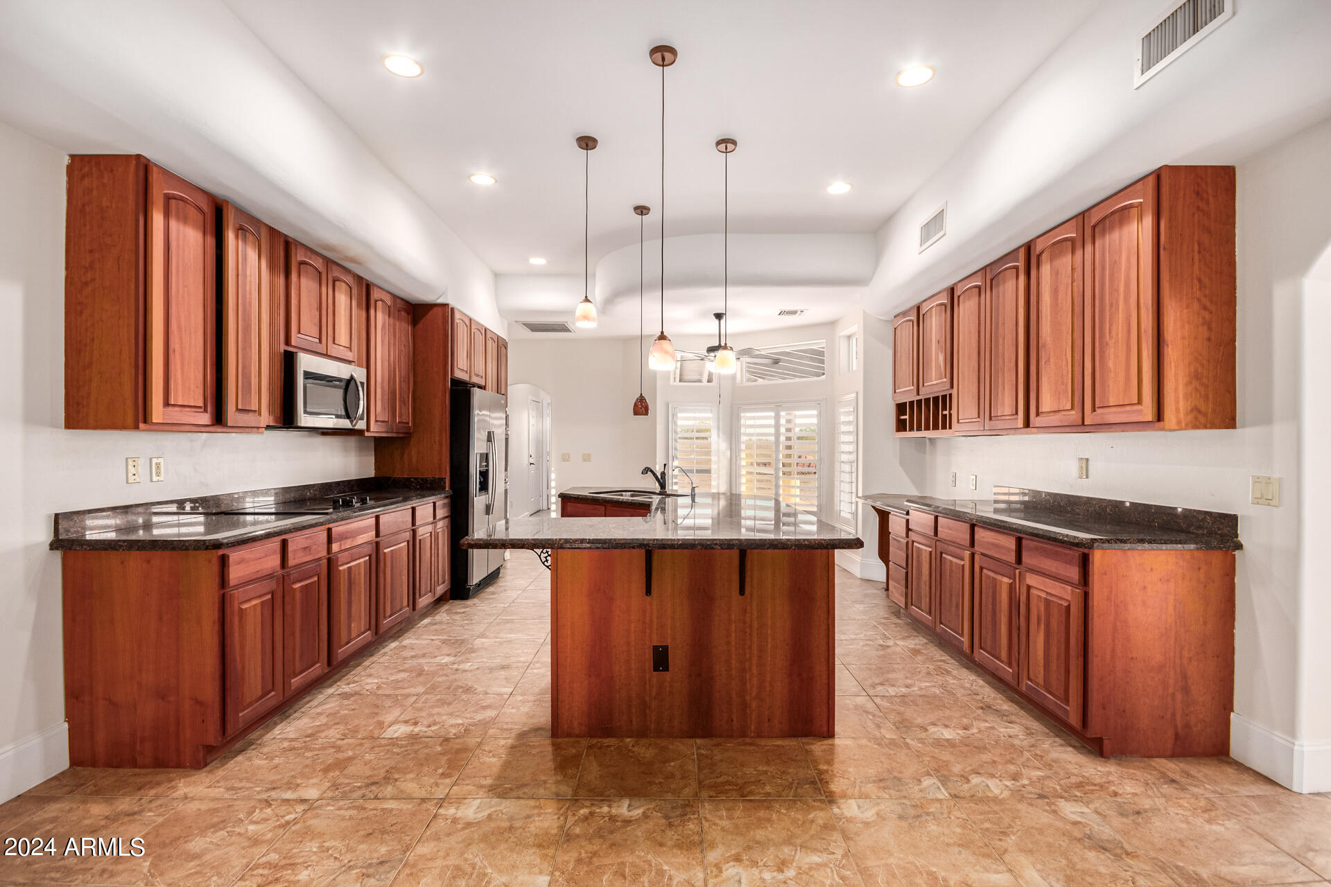 10589 West Harmon Road Eloy, AZ 85131 - Photo 33 of 82 a large kitchen with stainless steel appliances granite countertop wooden cabinets a stove a sink a oven and a refrigerator