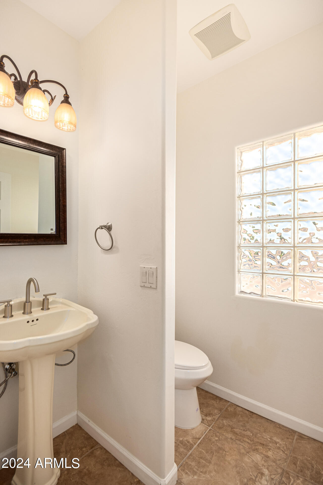 10589 West Harmon Road Eloy, AZ 85131 - Photo 37 of 82 a bathroom with a sink a toilet and a window