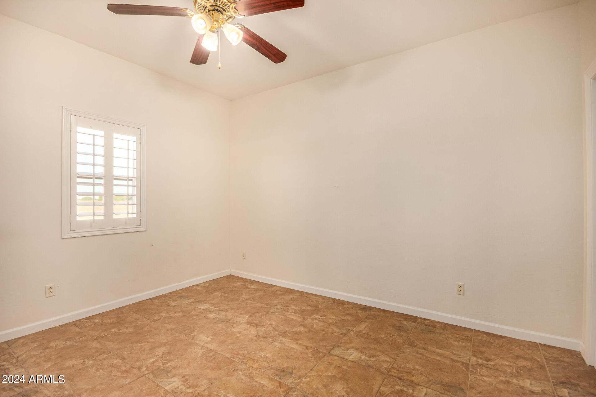 10589 West Harmon Road Eloy, AZ 85131 - Photo 45 of 82 an empty room with a window and a fan