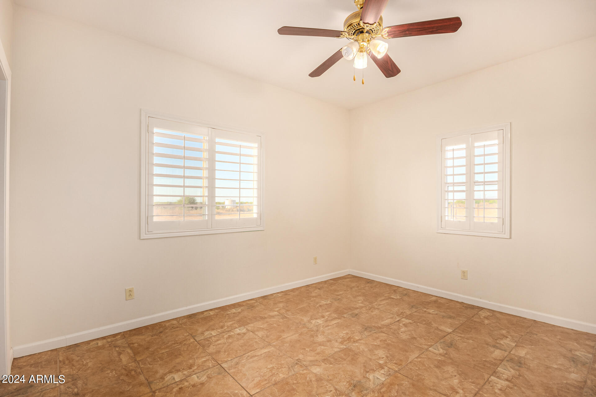 10589 West Harmon Road Eloy, AZ 85131 - Photo 46 of 82 an empty room with windows and fan