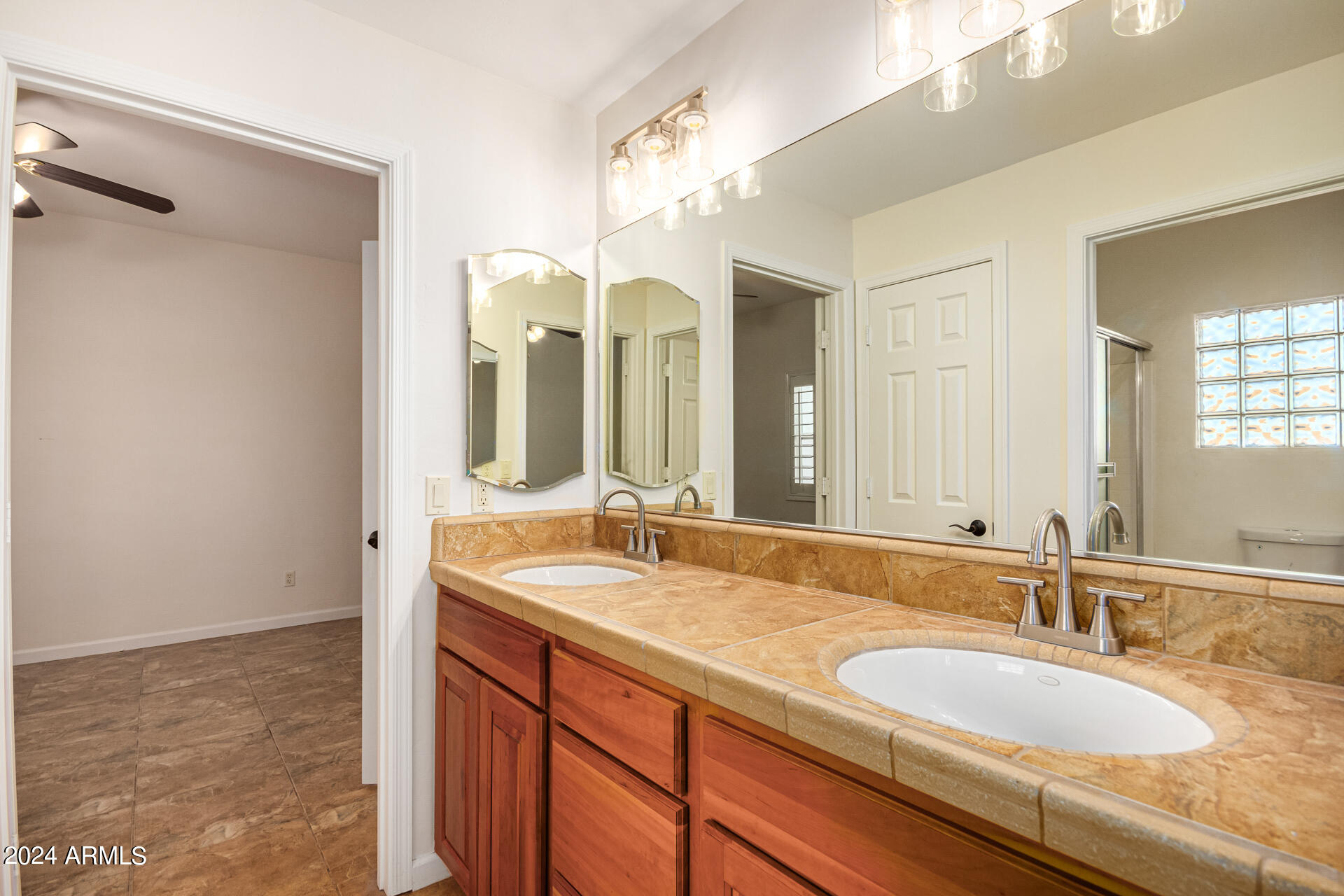 10589 West Harmon Road Eloy, AZ 85131 - Photo 49 of 82 a bathroom with a granite countertop double vanity sink and a mirror