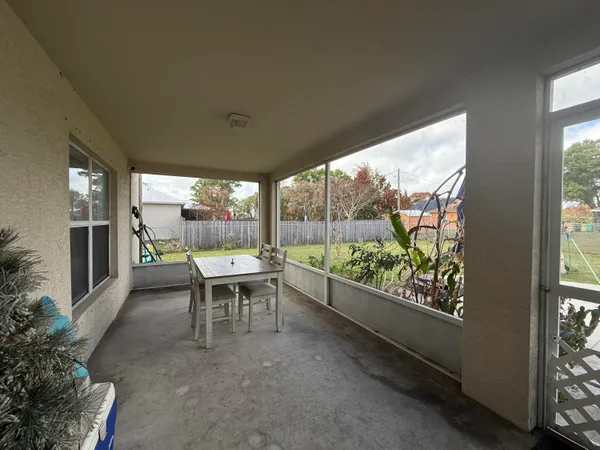 a room with furniture and a floor to ceiling window