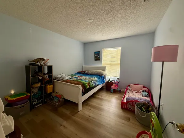 a bedroom with a bed and a lamp