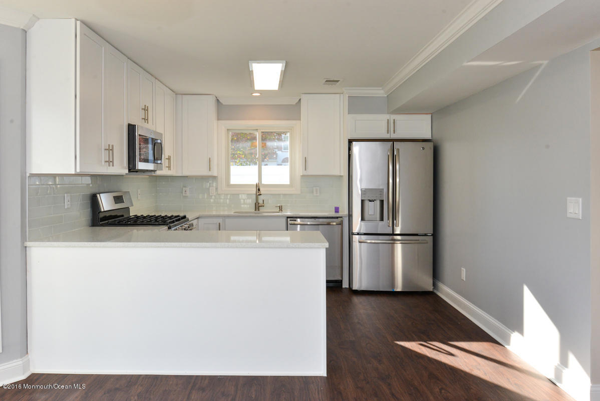 93 Friendship Road Howell, NJ 07731 - Photo 15 of 51 a kitchen with a refrigerator and a sink