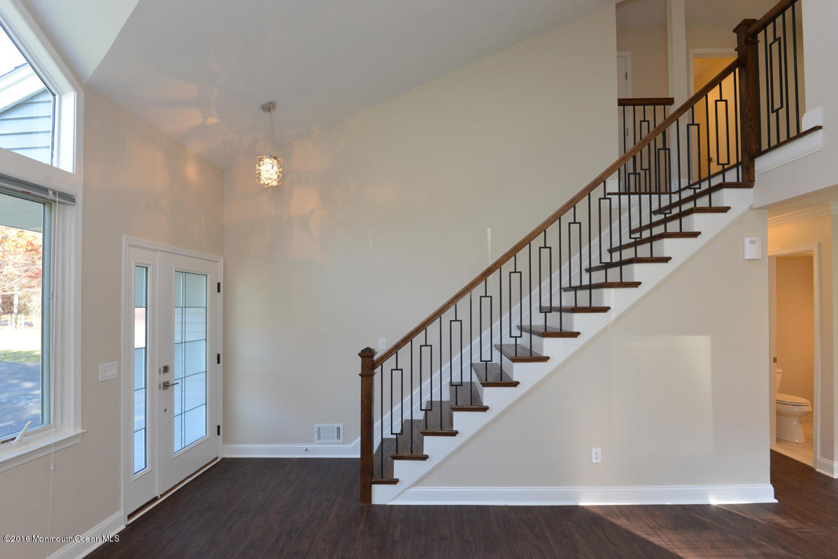 93 Friendship Road Howell, NJ 07731 - Photo 20 of 51 a view of staircase with wooden floor and a window