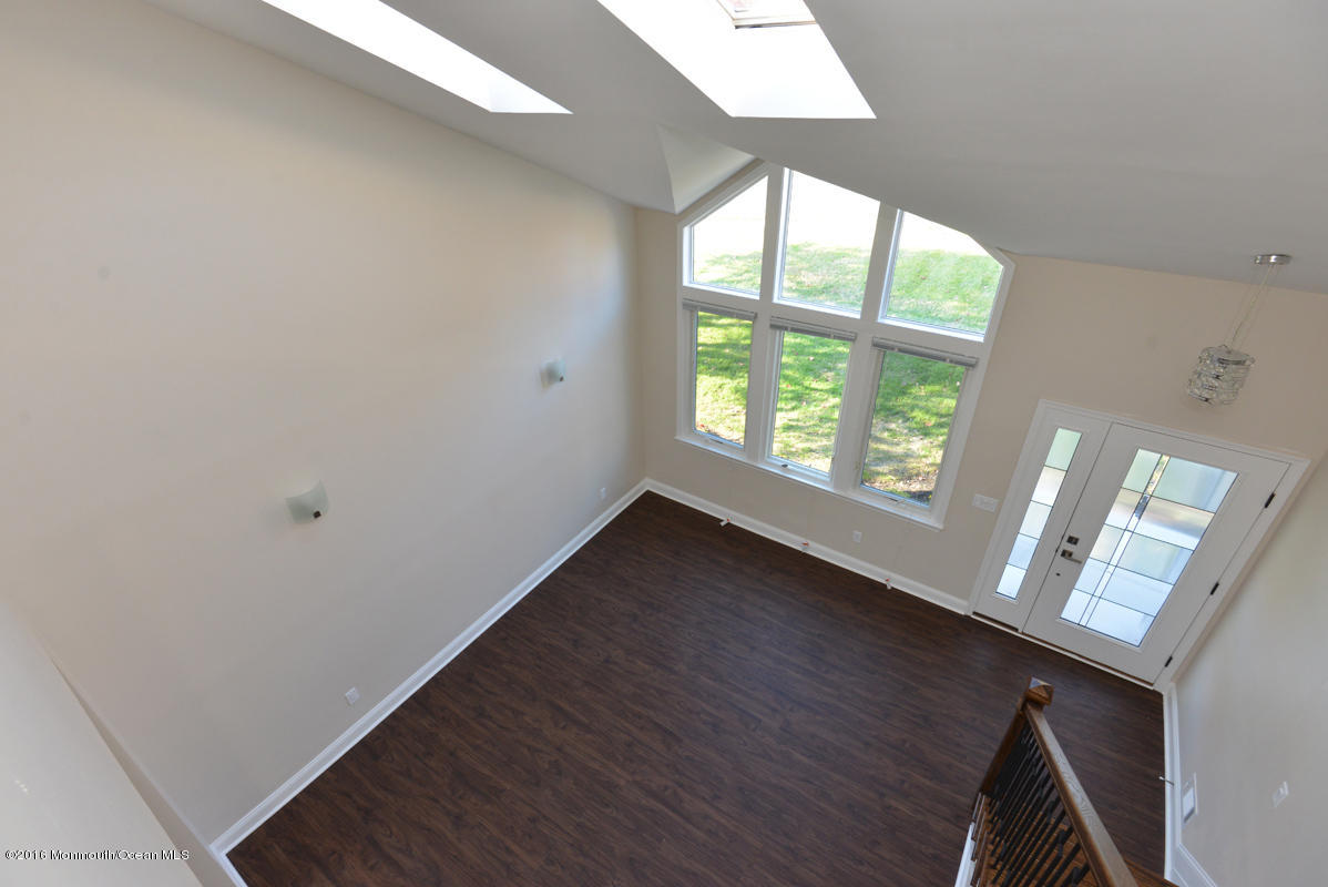 93 Friendship Road Howell, NJ 07731 - Photo 24 of 51 a view of an empty room with wooden floor and a window