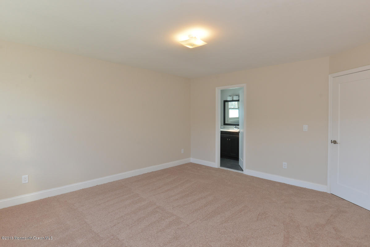 93 Friendship Road Howell, NJ 07731 - Photo 27 of 51 a view of an empty room with window and wooden floor