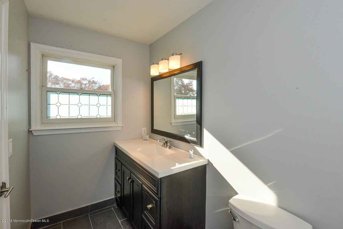 93 Friendship Road Howell, NJ 07731 - Photo 29 of 51 a bathroom with a sink vanity mirror and toilet