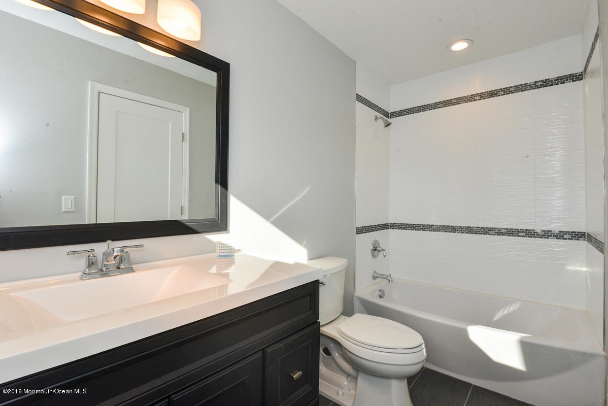 93 Friendship Road Howell, NJ 07731 - Photo 30 of 51 a bathroom with a sink a toilet a mirror and shower