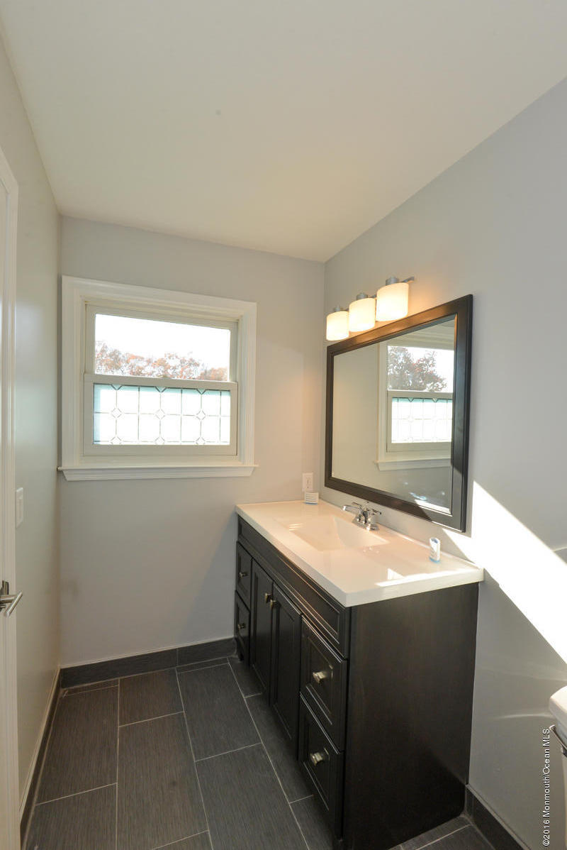 93 Friendship Road Howell, NJ 07731 - Photo 31 of 51 a bathroom with a sink and a mirror