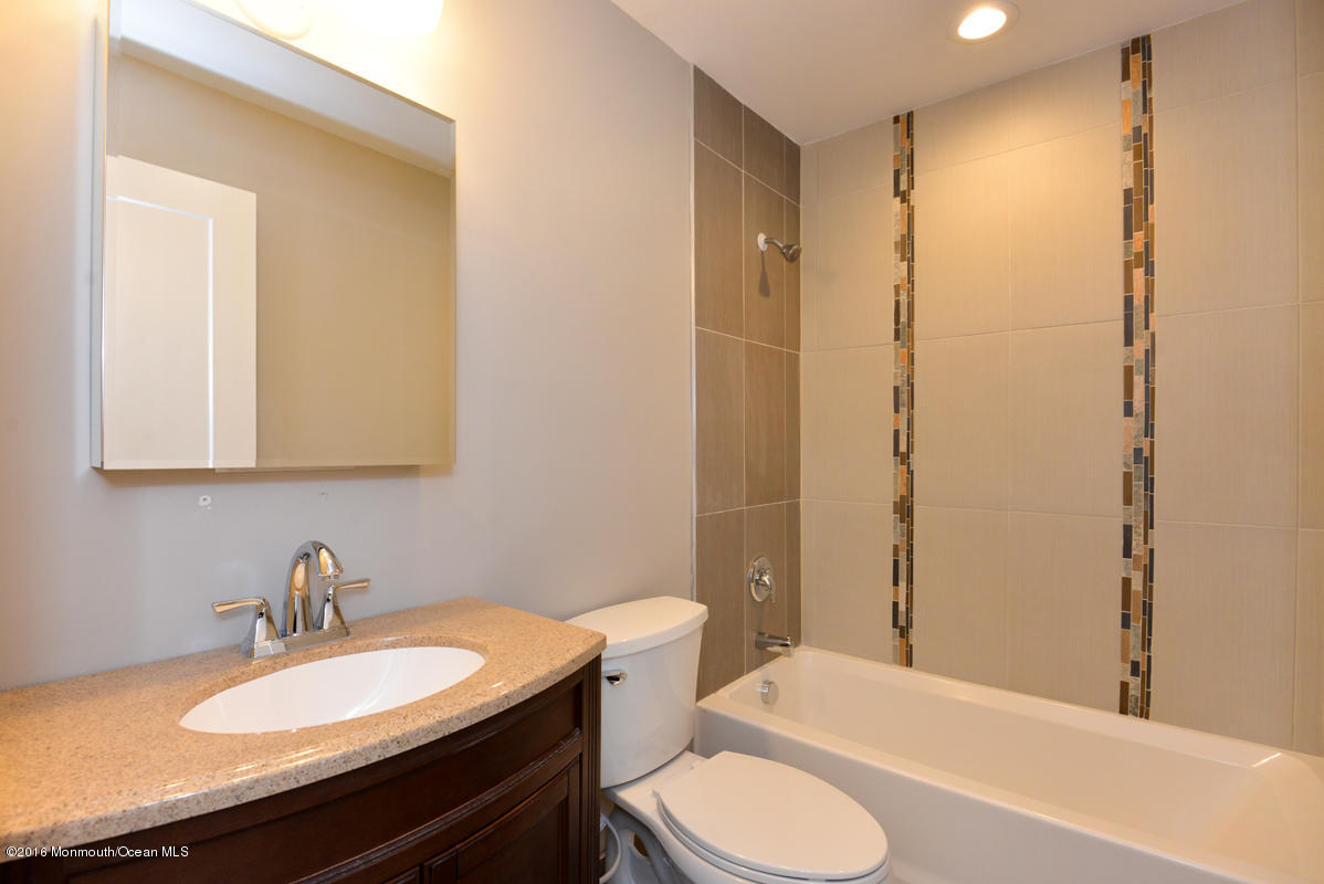 93 Friendship Road Howell, NJ 07731 - Photo 36 of 51 a bathroom with a granite countertop sink toilet a mirror and shower