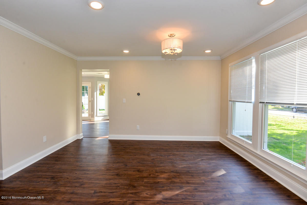 93 Friendship Road Howell, NJ 07731 - Photo 4 of 51 an empty room with wooden floor and windows
