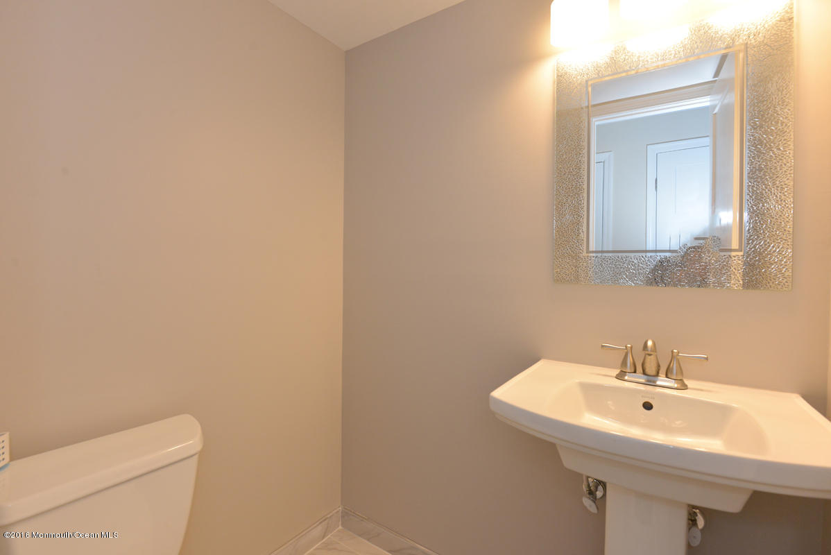 93 Friendship Road Howell, NJ 07731 - Photo 42 of 51 a bathroom with a sink a toilet and mirror