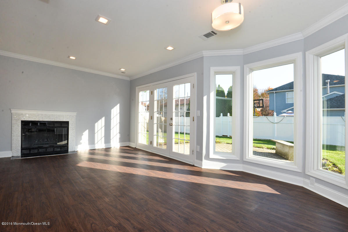 93 Friendship Road Howell, NJ 07731 - Photo 6 of 51 an empty room with wooden floor and windows