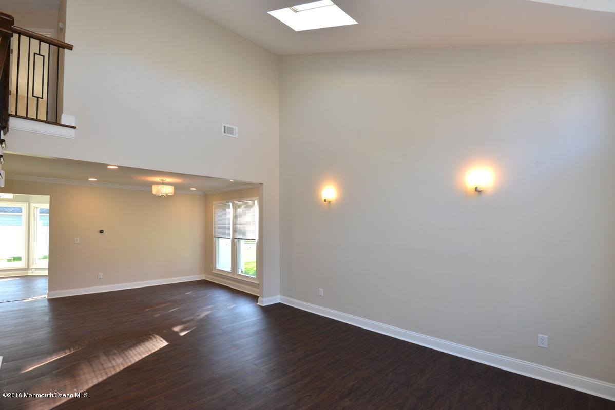 93 Friendship Road Howell, NJ 07731 - Photo 8 of 51 an empty room with wooden floor and windows