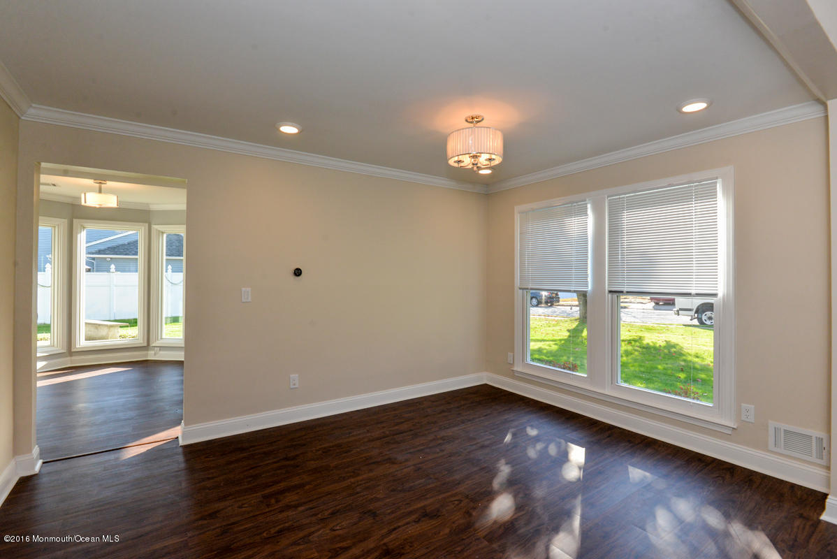 93 Friendship Road Howell, NJ 07731 - Photo 9 of 51 an empty room with wooden floor and windows
