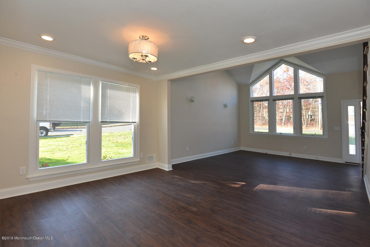 93 Friendship Road Howell, NJ 07731 - Photo 10 of 51 an empty room with wooden floor and windows