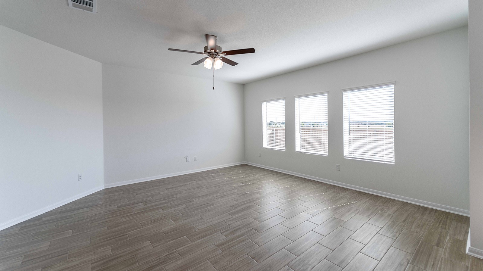 13613 Endless Narrow Lane Elgin, TX 78621 - Photo 15 of 16 a view of an empty room with wooden floor and a window