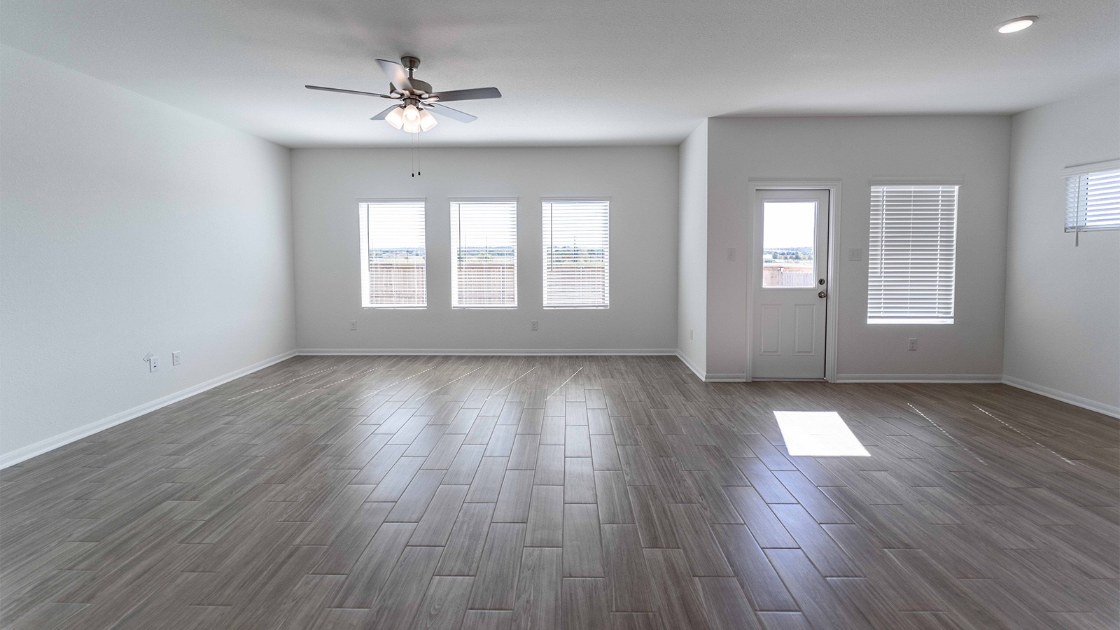 13613 Endless Narrow Lane Elgin, TX 78621 - Photo 2 of 16 an empty room with wooden floor and windows