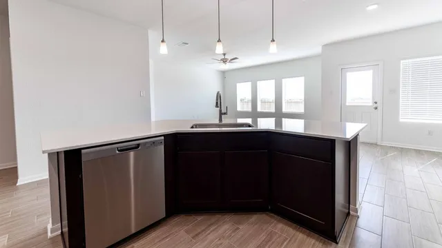 a kitchen with a sink a refrigerator and window