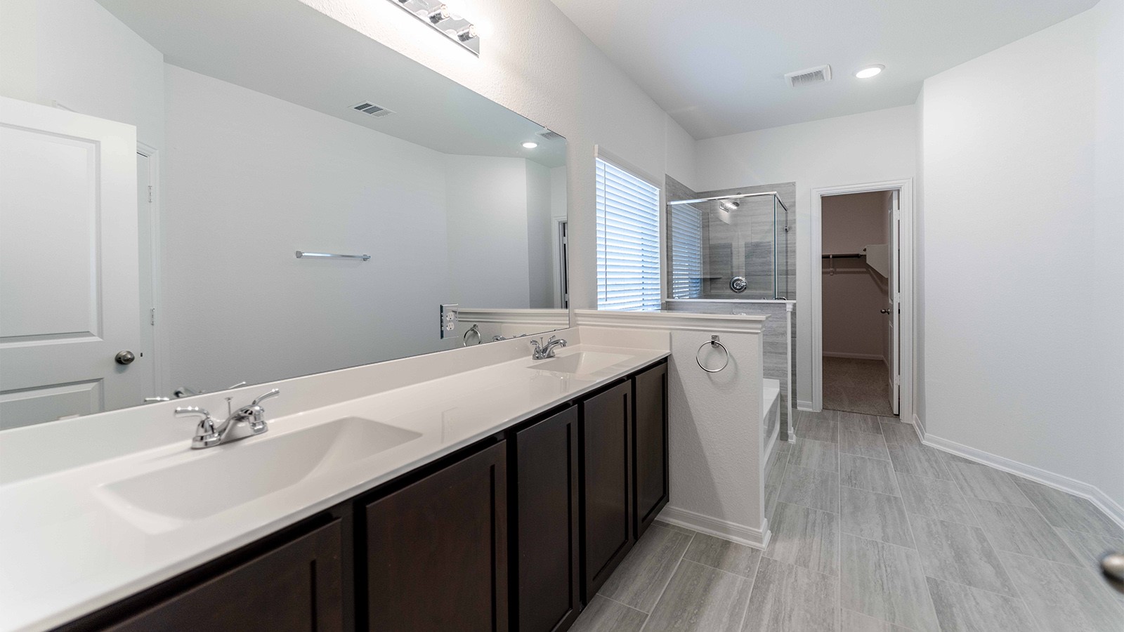 13613 Endless Narrow Lane Elgin, TX 78621 - Photo 9 of 16 a bathroom with a double vanity sink and mirror
