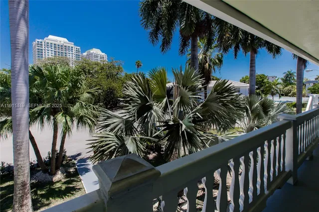 a view of a palm plant that is in front of a building