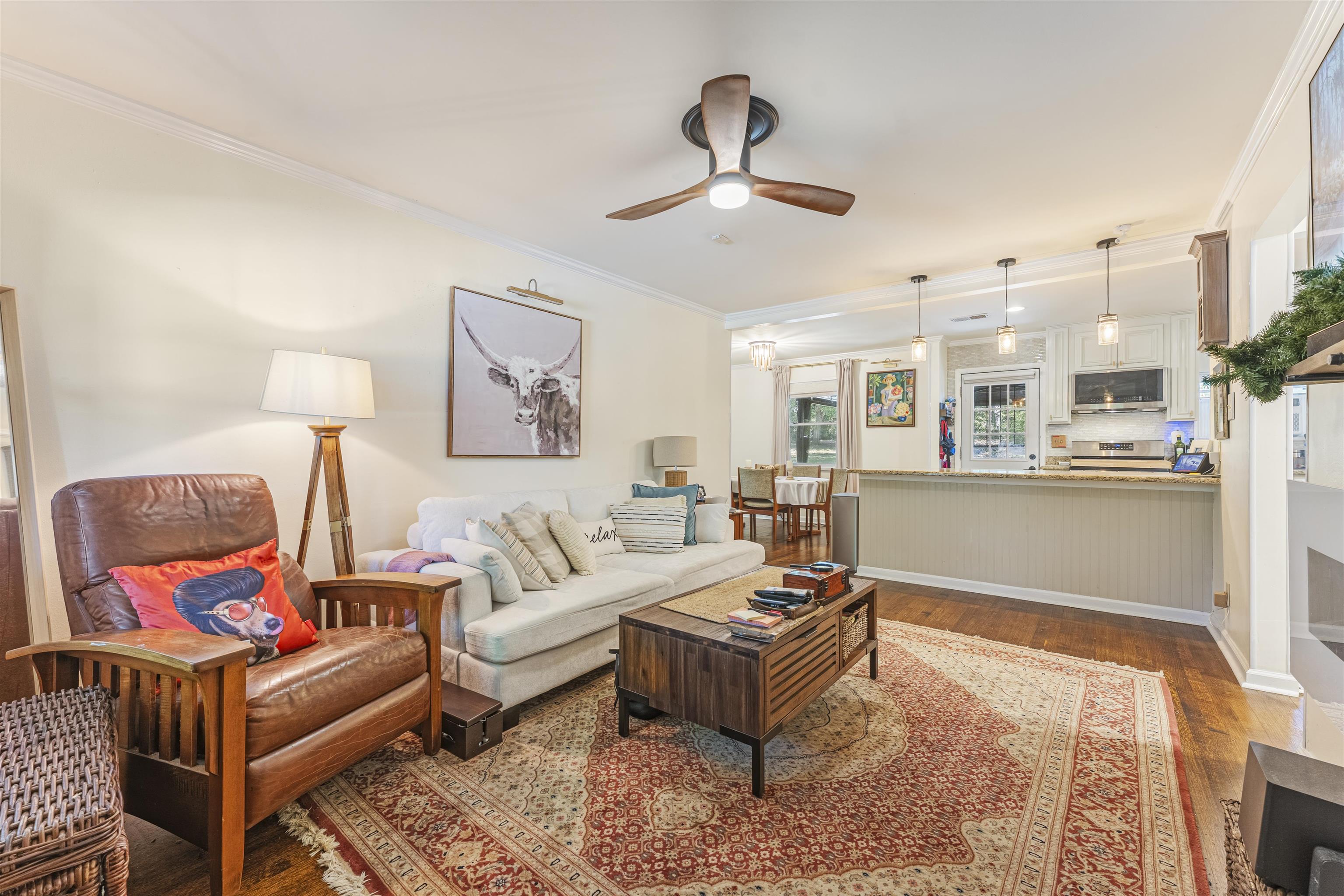 5271 Princeton Road Memphis, TN 38120 - Photo 28 of 30 Open-concept living area featuring wood-finish flooring, a contemporary ceiling fan, and crown molding