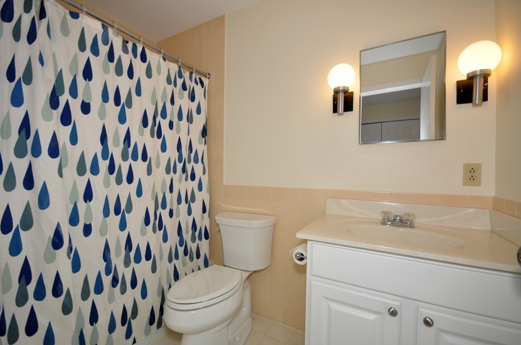 29 Concord Greene, Unit 4 Concord, MA 01742 - Photo 14 of 23 a bathroom with a sink and a mirror