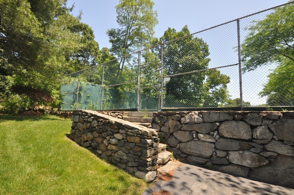 29 Concord Greene, Unit 4 Concord, MA 01742 - Photo 19 of 23 a view of a yard with wooden fence