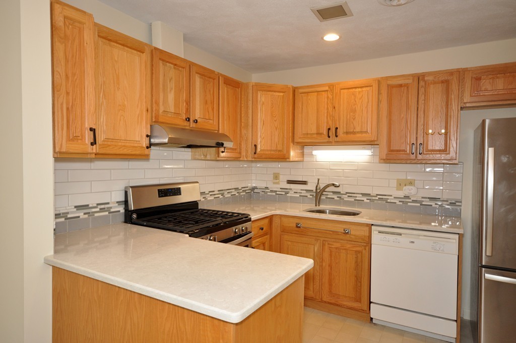 29 Concord Greene, Unit 4 Concord, MA 01742 - Photo 3 of 23 a kitchen with stainless steel appliances granite countertop a stove a sink dishwasher and a refrigerator