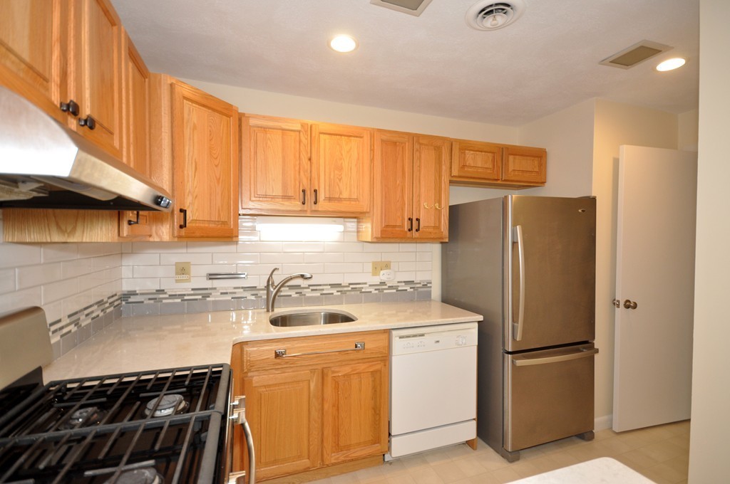29 Concord Greene, Unit 4 Concord, MA 01742 - Photo 4 of 23 a kitchen with a refrigerator sink stove and cabinets