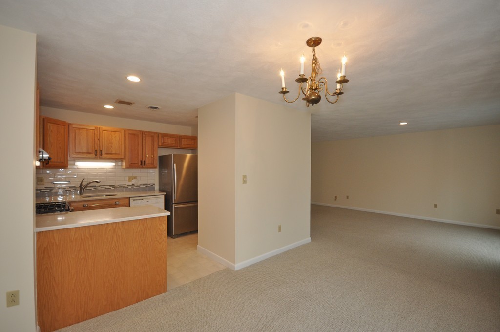 29 Concord Greene, Unit 4 Concord, MA 01742 - Photo 6 of 23 a view of a kitchen with refrigerator and microwave