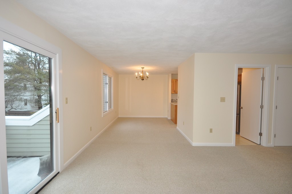 29 Concord Greene, Unit 4 Concord, MA 01742 - Photo 8 of 23 a view of empty room with wooden floor and fan