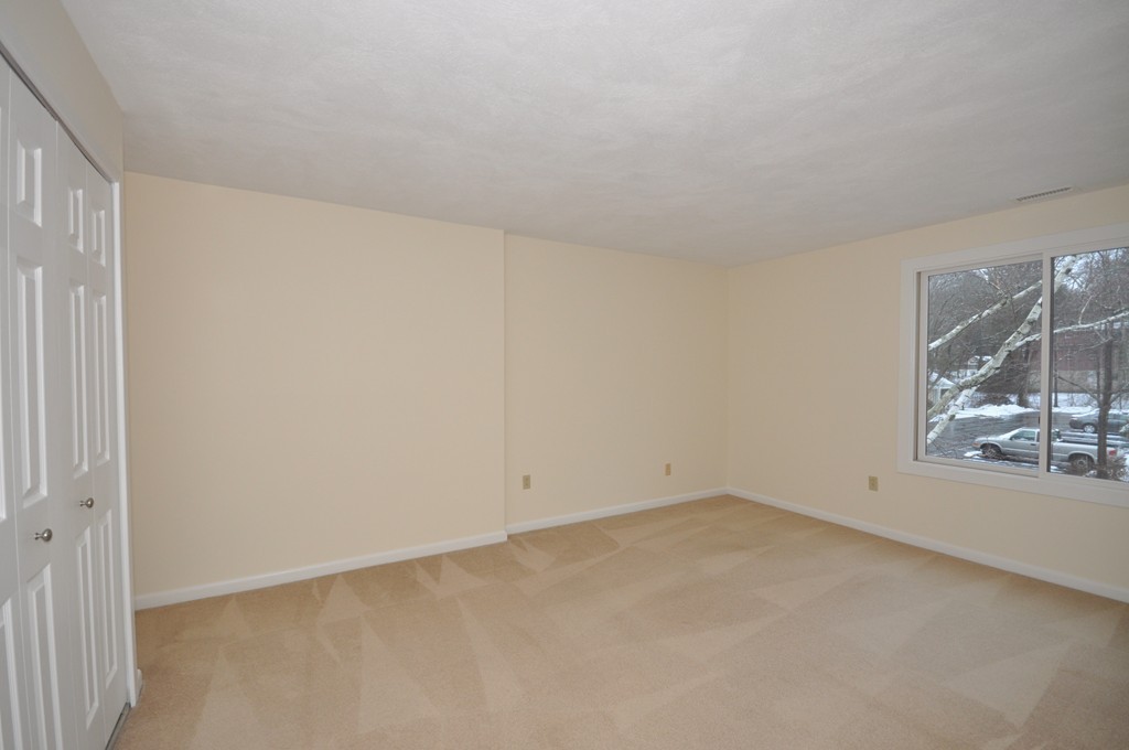 29 Concord Greene, Unit 4 Concord, MA 01742 - Photo 10 of 23 an empty room with a empty space and windows