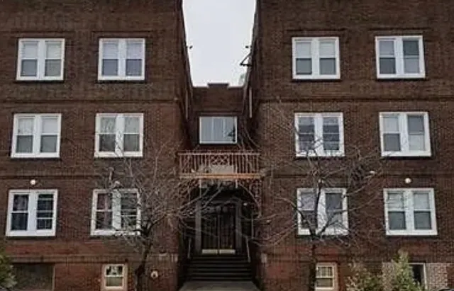 a front view of a building with many windows