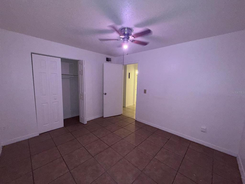 719 Michigan Court, Unit 3 St. Cloud, FL 34769 - Photo 15 of 17 a view of a livingroom with a ceiling fan and window