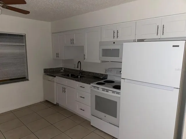 a kitchen with cabinets stainless steel appliances and a counter top space