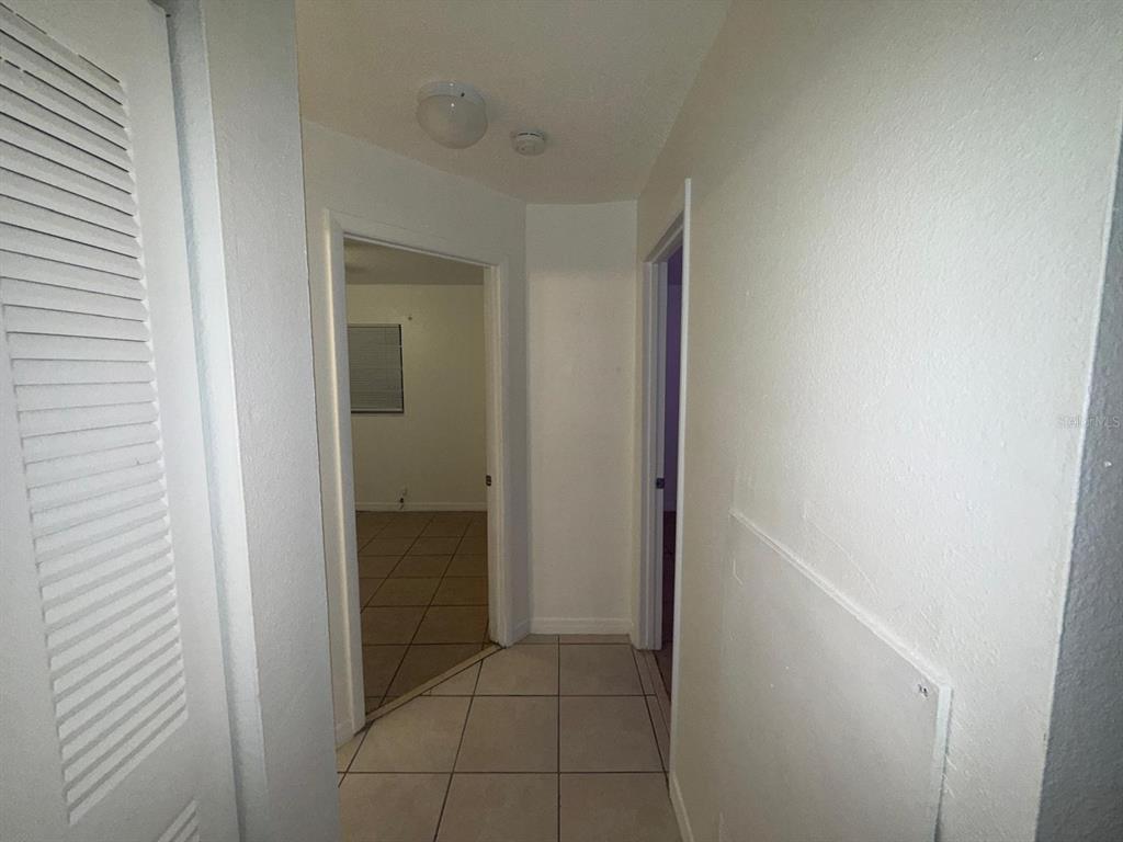 719 Michigan Court, Unit 3 St. Cloud, FL 34769 - Photo 10 of 17 a view of a bathroom from a hallway