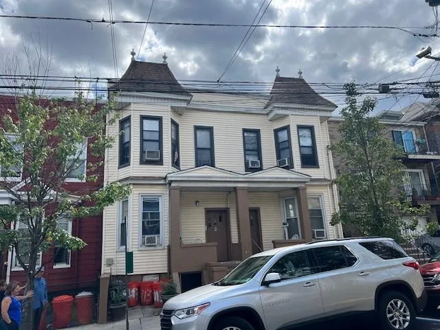 a front view of a building with parking space