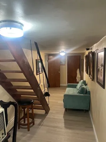 a room with two chairs and wooden floor