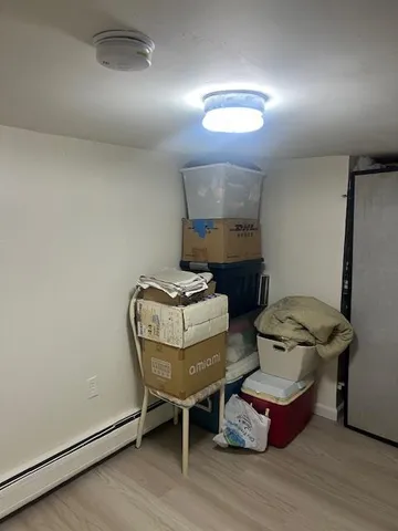 a spacious bedroom with a bed and a dresser