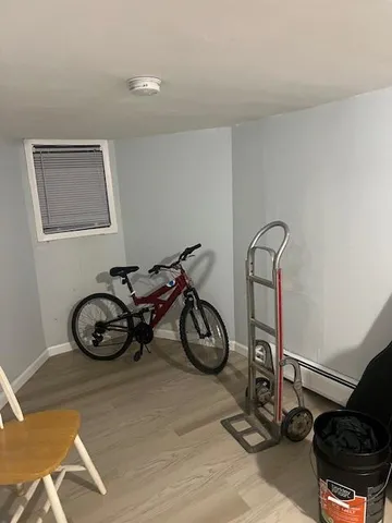 a view of a hallway with chairs and a potted plant