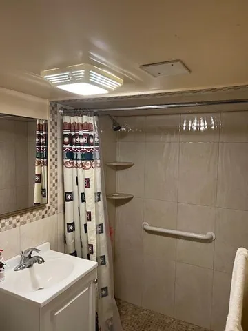 a bathroom with a sink toilet and shower