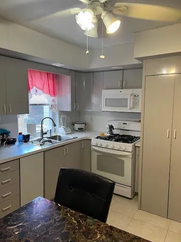 a room with a refrigerator and a window