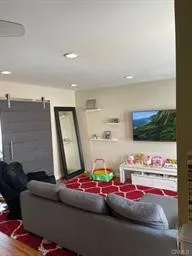 a room with furniture and a flat screen tv