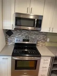 a view of a balcony with furniture and wooden floor