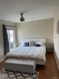 a bedroom with a bed and wooden floor