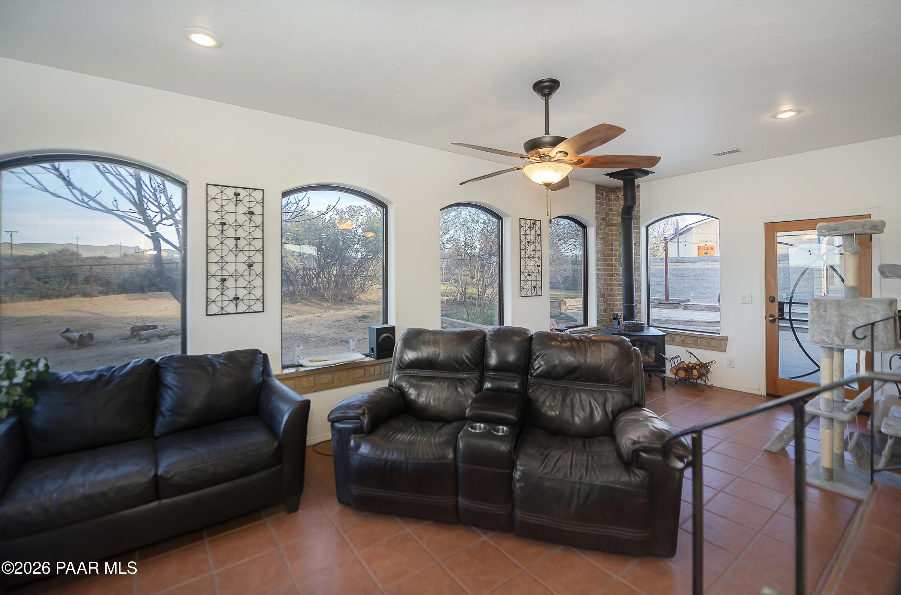 6565 Musgrove Road Skull Valley, AZ 86338 - Photo 20 of 65 a living room with furniture a large window and a chandelier