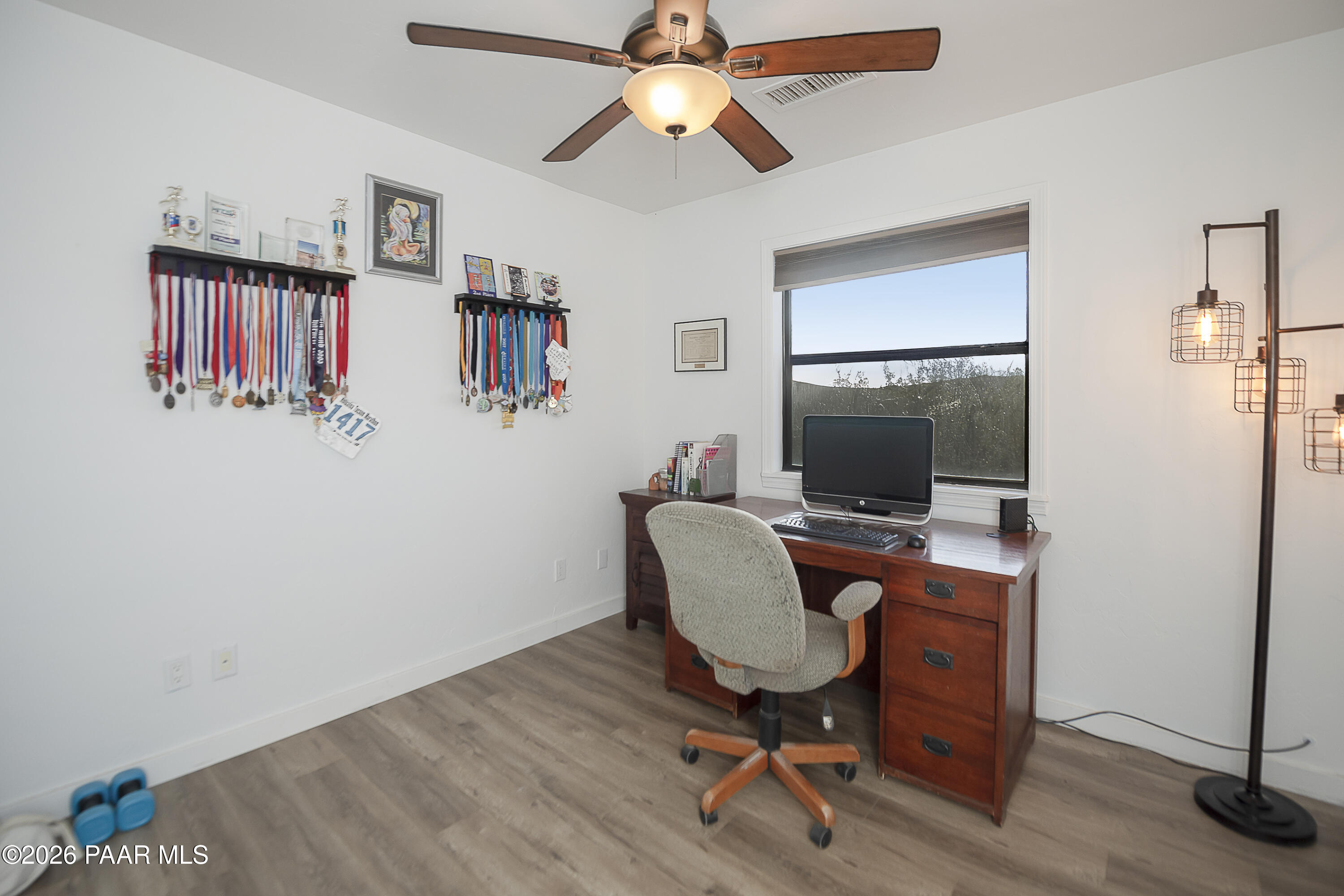 6565 Musgrove Road Skull Valley, AZ 86338 - Photo 21 of 65 a workspace with furniture wooden floor and a chandelier fan